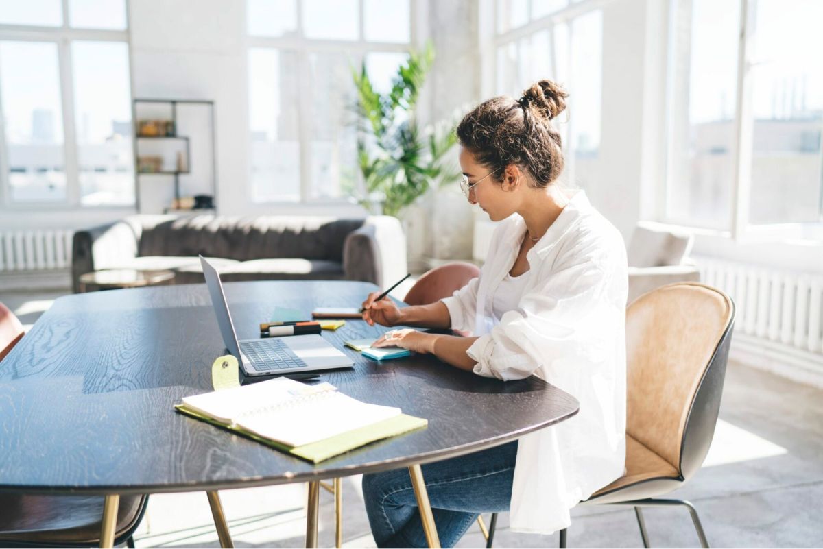 Ecommerce strategist planning a store redesign at a bright dining table